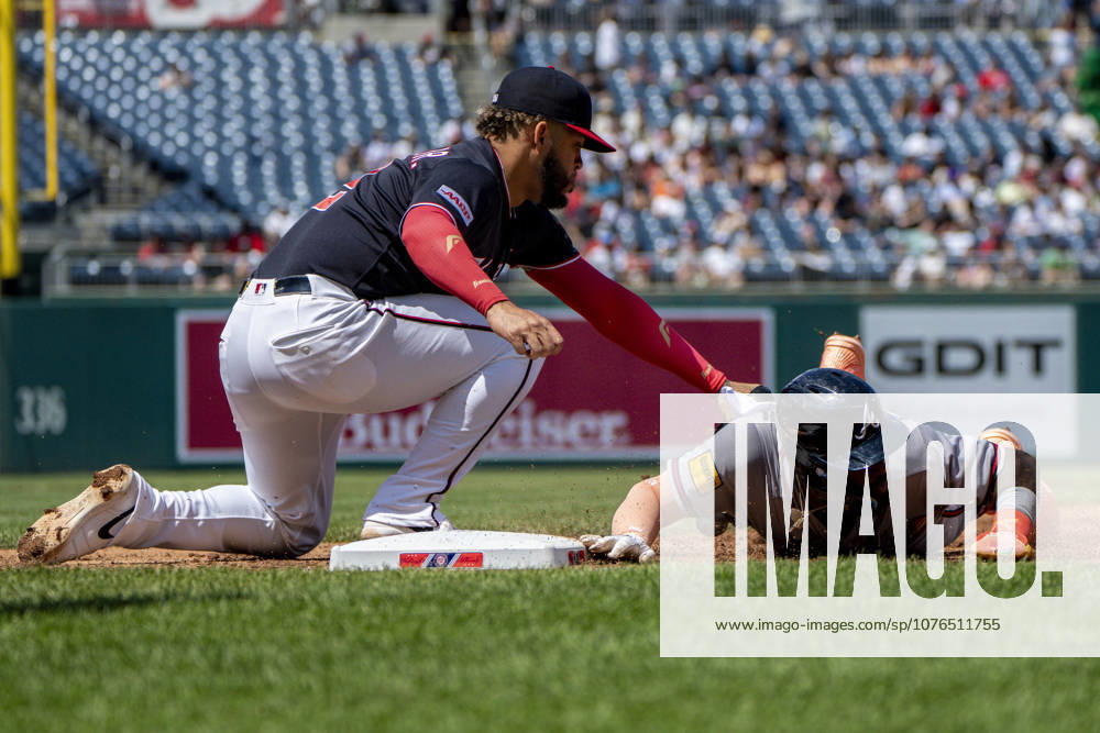 Atlanta Braves center fielder Michael Harris (23) slides into first base as Washington Nationals first baseman Luis Garcia Jr. (2) tags during the top of the fourth inning during a game at Nationals Park in Washington, DC on Thursday, April 23, 2026. WAP20260423318 BONNIExCASH