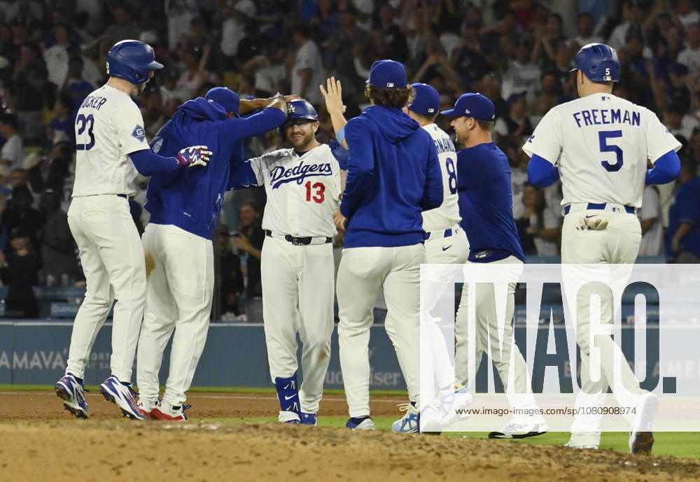 Los Angeles Dodgers Max Muncy (13) celebrates with teammates after hitting a walk-off RBI single in the tenth inning against the Kansas City Royals at Dodger Stadium in Los Angeles on Tuesday, August 11, 2026. LAP2026081101 JIMxRUYMEN