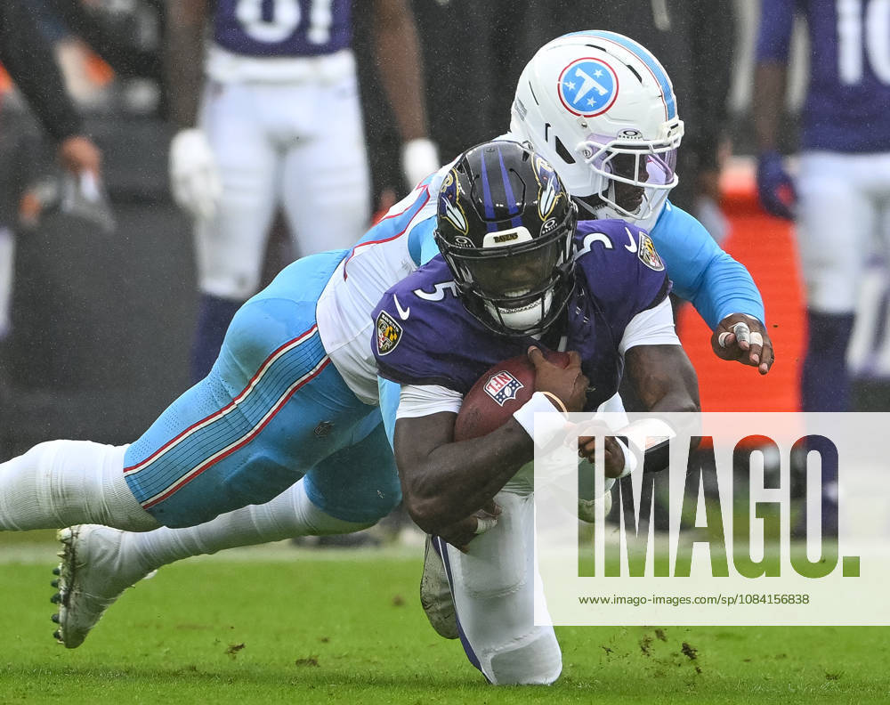 Baltimore Ravens quarterback Tyler Huntley (5) earns an 8 yard gain before Tennessee Titans defensive end Jacob Martin (57) tackles him during the fourth quarter at M&T Bank Stadium in Baltimore, Maryland, on Sunday, October 4, 2026. Baltimore won 24-18. BAL20261004115 DAVIDxTULIS