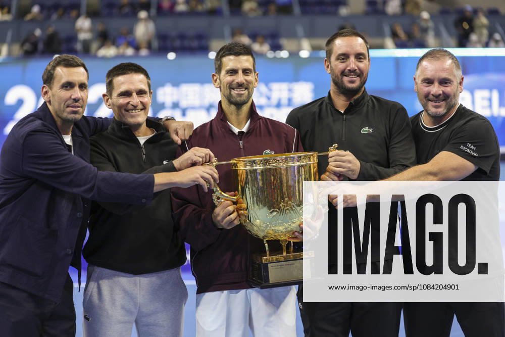 (261006) -- BEIJING, Oct. 6, 2026 -- Winner Novak Djokovic of Serbia poses for photos with his team staff after the awarding ceremony for the men s singles final at 2026 China Open tennis tournament in Beijing, China, Oct. 6, 2026. ) (SP)CHINA-BEIJING-TENNIS-CHINA OPEN-MEN S SINGLES-AWARDING CEREMONY(CN) BaixXuefei