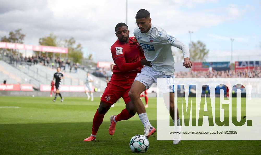Herren, Fussball, Saison 2026 2027, 3. Liga, 8. Spieltag: FC Wuerzburger Kickers - FC Hansa Rostock v.li.: Franck Evina (FC Wuerzburger Kickers), Ouassim Karada (FC Hansa Rostock) Wuerzburg AKON ARENA Bayern Deutschland