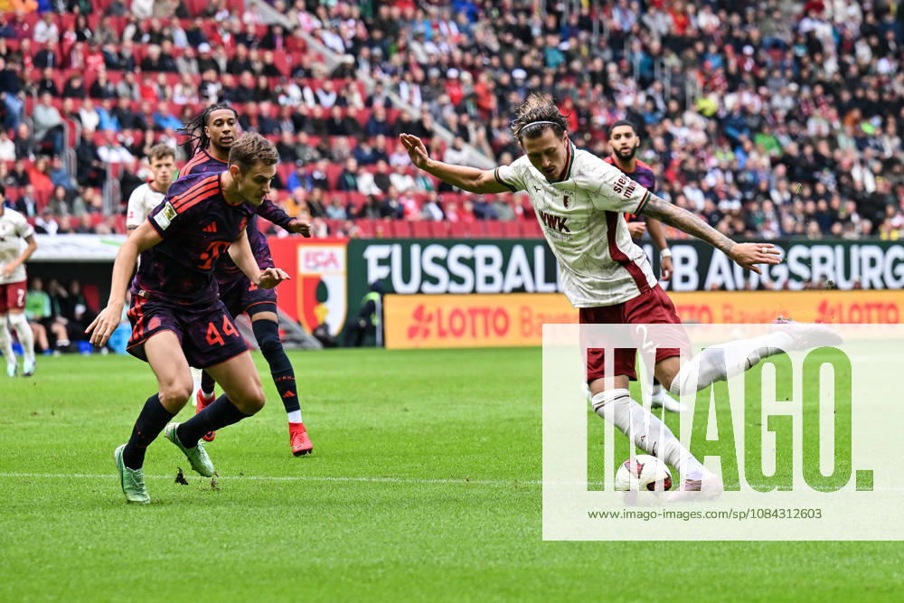 AUGSBURG, GERMANY; 10. OCTOBER: tackle between Josip STANISIC (FC Bayern Munich 44) and Calvin BRACKELMANN (FC Augsburg 2) during the Bundesliga Match between FC Augsburg vs. FC Bayern Munich at Matchday 5 at WWK-Arena DFL REGULATIONS PROHIBIT ANY USE OF PHOTOGRAPHS AS IMAGE SEQUENCES AND OR QUASI-VIDEO