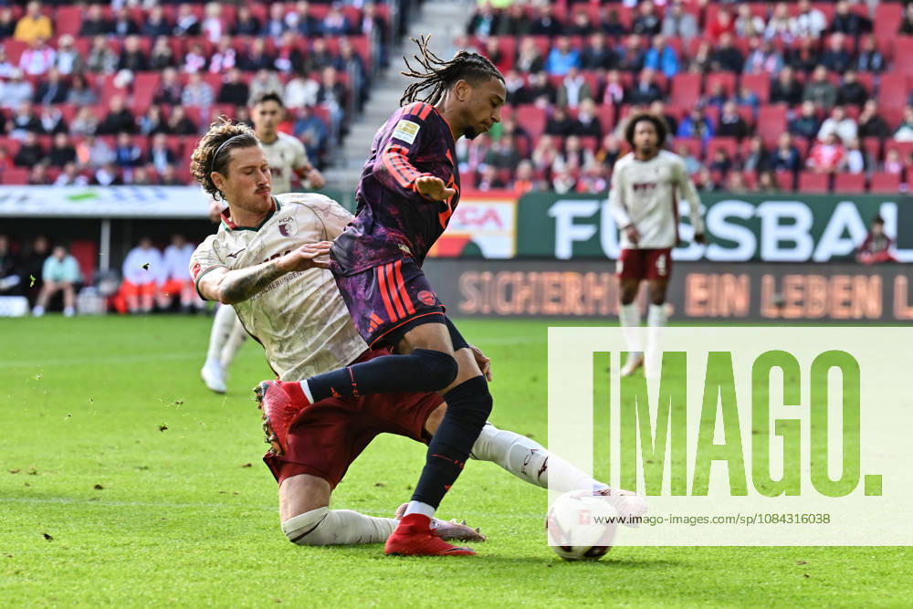 AUGSBURG, GERMANY; 10. OCTOBER: tackle between Michael OLISE (FC Bayern Munich 17) and Calvin BRACKELMANN (FC Augsburg 2) during the Bundesliga Match between FC Augsburg vs. FC Bayern Munich at Matchday 5 at WWK-Arena DFL REGULATIONS PROHIBIT ANY USE OF PHOTOGRAPHS AS IMAGE SEQUENCES AND OR QUASI-VIDEO