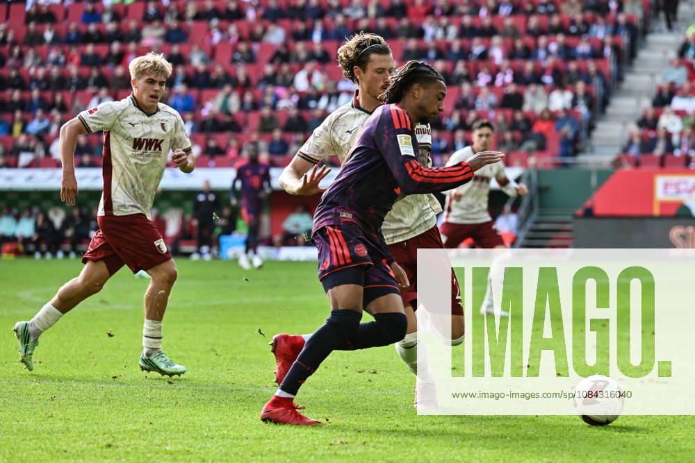 AUGSBURG, GERMANY; 10. OCTOBER: tackle between Michael OLISE (FC Bayern Munich 17) and Calvin BRACKELMANN (FC Augsburg 2) during the Bundesliga Match between FC Augsburg vs. FC Bayern Munich at Matchday 5 at WWK-Arena DFL REGULATIONS PROHIBIT ANY USE OF PHOTOGRAPHS AS IMAGE SEQUENCES AND OR QUASI-VIDEO