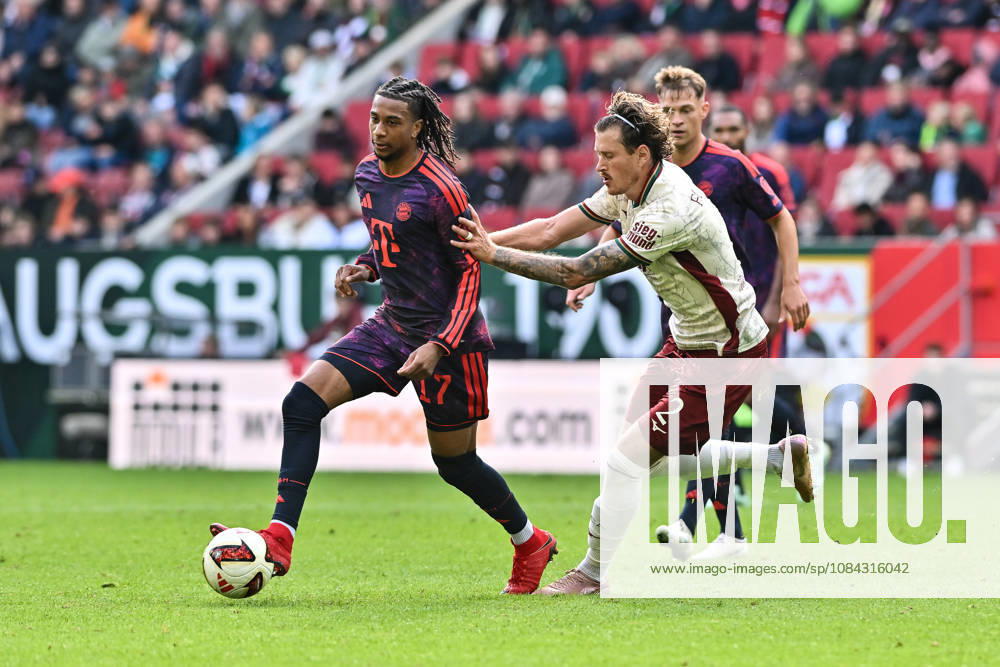 AUGSBURG, GERMANY; 10. OCTOBER: tackle between Michael OLISE (FC Bayern Munich 17) and Calvin BRACKELMANN (FC Augsburg 2) during the Bundesliga Match between FC Augsburg vs. FC Bayern Munich at Matchday 5 at WWK-Arena DFL REGULATIONS PROHIBIT ANY USE OF PHOTOGRAPHS AS IMAGE SEQUENCES AND OR QUASI-VIDEO
