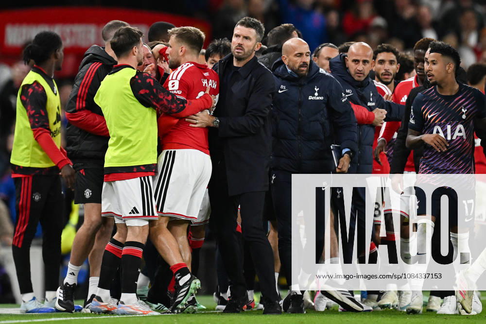 MANCHESTER, ENGLAND, OCT 10: Michael Carrick head coach of Manchester United, ManU pulls away Luke Shaw of Manchester United after Rodrigo Bentancur (Not pictured) of Tottenham Hotspur is sent off during the Premier League match between Manchester United and Tottenham Hotspur at Old Trafford in Manchester, England (Will Palmer Sports Press Photo)