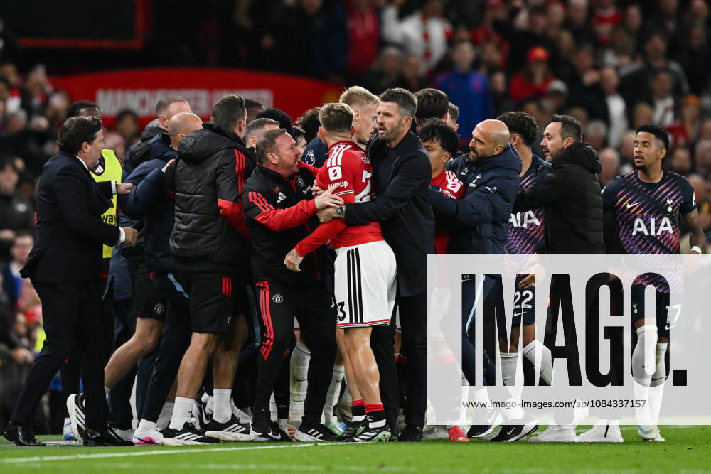 MANCHESTER, ENGLAND, OCT 10: Michael Carrick head coach of Manchester United, ManU pulls away Luke Shaw of Manchester United after Rodrigo Bentancur (Not pictured) of Tottenham Hotspur is sent off during the Premier League match between Manchester United and Tottenham Hotspur at Old Trafford in Manchester, England (Will Palmer Sports Press Photo)