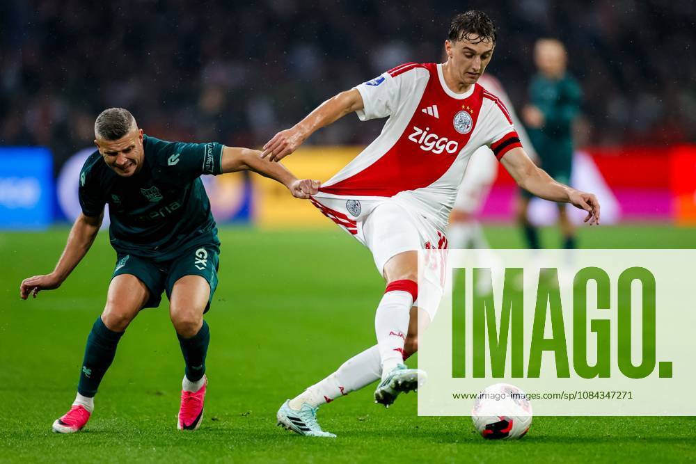 , JohanCruyff Arena , season 2026 2027 , Dutch Eredivisie football , Match between Ajax and NEC Nijmegen , picture shows NEC Nijmegen player Bryan Linssen challenges Ajax player Youri Baas Ajax - NEC x208127209x