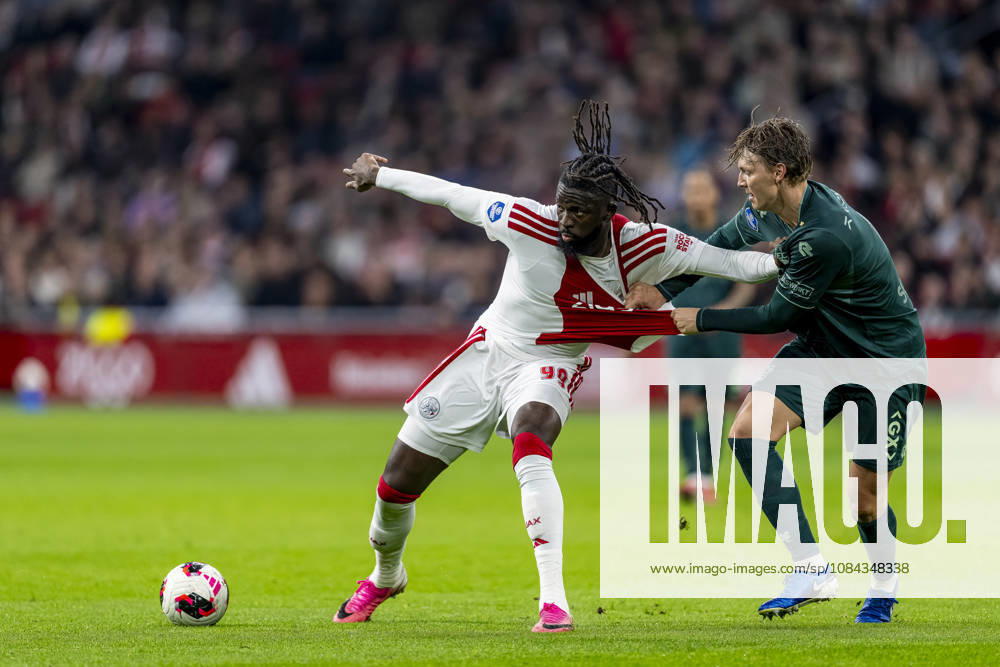 AMSTERDAM - (l-r) AFC Ajax Amsterdam forward Toluwalase Arokodare and N.E.C. Nijmegen defender Perr Schuurs during the Vriendenloterij Eredivisie match between Ajax and N.E.C. at Johan Cruijff ArenA on 10 oktober 2026 in Amsterdam , Nederland. (Photo by DeFodi Images) -