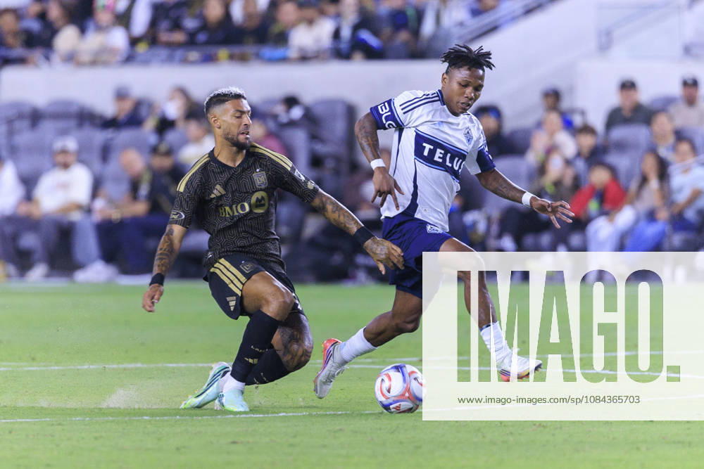 Denis Bouanga 99 of the Los Angeles Football Club falls as he and Edier Ocampo 18 of the Vancouver Whitecaps struggle for possession of the ball during their regular season MLS, Fussball Herren, USA game on Saturday October 10, 2026 at the BMO Stadium in Los Angeles, California. ARIANA RUIZ PI LAFC Vs. Whitecaps - ZUMAp124 20261010_zaa_p124_011