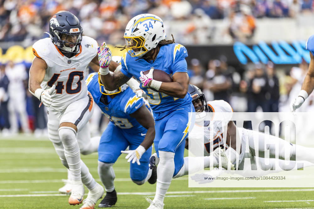 Los Angeles Chargers running back Keaton Mitchell (34) escapes a tackle-attempt by Denver Broncos Outside Linebacker Que Robinson (51) during an NFL, American Football Herren, USA football game, in Inglewood, Calif. on Sunday Oct. 11, 2026. Inglewood USA - ZUMAc68_ 20261011_zaf_c68_034