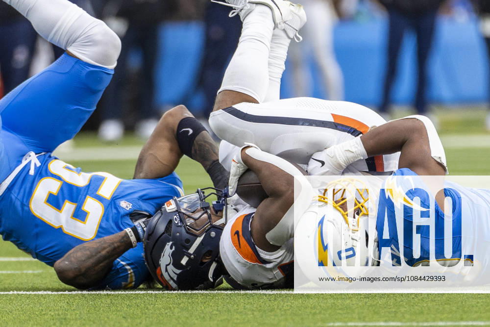 Denver Broncos Running Back J.K. Dobbins (27) is brought down by Los Angeles Chargers linebacker sDel Shawn Phillips (53) and Daiyan Henley (0) during an NFL, American Football Herren, USA football game, in Inglewood, Calif. on Sunday Oct. 11, 2026. Inglewood USA - ZUMAc68_ 20261011_zaf_c68_022
