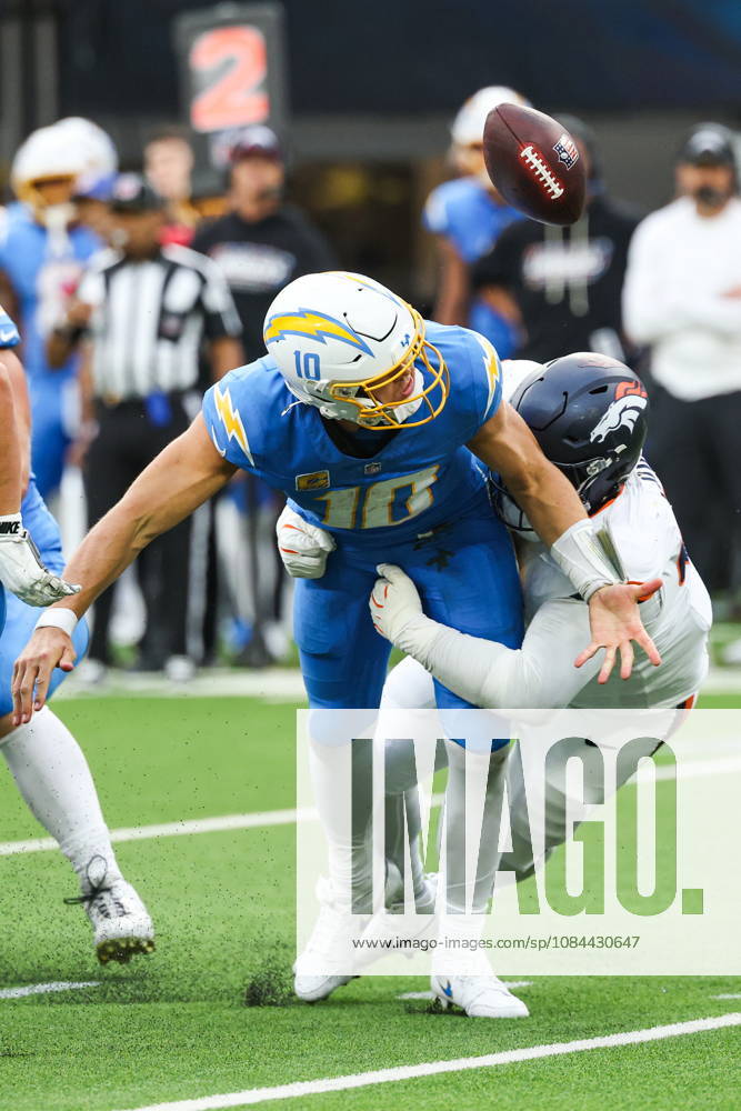 NFL, American Football Herren, USA - Los Angeles Chargers vs Denver Broncos Los Angeles Chargers quarterback Justin Herbert (10) recovers the football after fumbling during a sack by Denver Broncos defensive tackle D.J. Jones (93) in the second half of an NFL football game at SoFi Stadium in Inglewood, California, USA, 11 October 2026. INGLEWOOD CALIFORNIA UNITED STATES