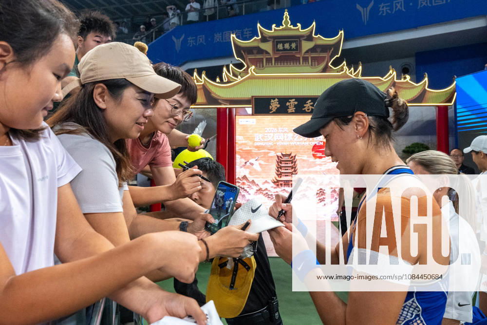 (261012) -- WUHAN, Oct. 12, 2026 -- Wang Xiyu (R, front) signs autographs for fans after the women s sinlges round of 64 match between Wang Xiyu of China and Wang Xinyu of China of the 2026 Wuhan Open tennis tournament in Wuhan, capital of central China s Hubei Province, Oct. 12, 2026. ) (SP)CHINA-WUHAN-TENNIS-WUHAN OPEN-WOMEN S SINGLES-ROUND OF 64 (CN) XiaoxYijiu