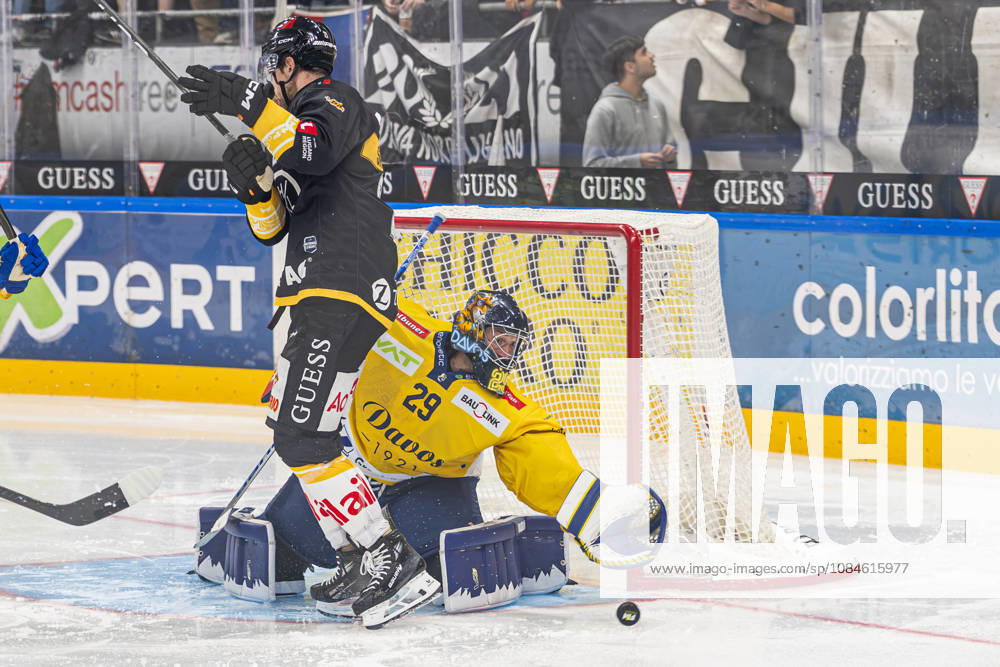 goalkeeper Sandro Aeschlimann of Davos in action despite Zach Sanford of Lugano L) in front of him during the game between HC Lugano v HC Davos at the Corner Arena on October 16, 2026 in Lugano, Switzerland. Lugano Ticino Switzerland