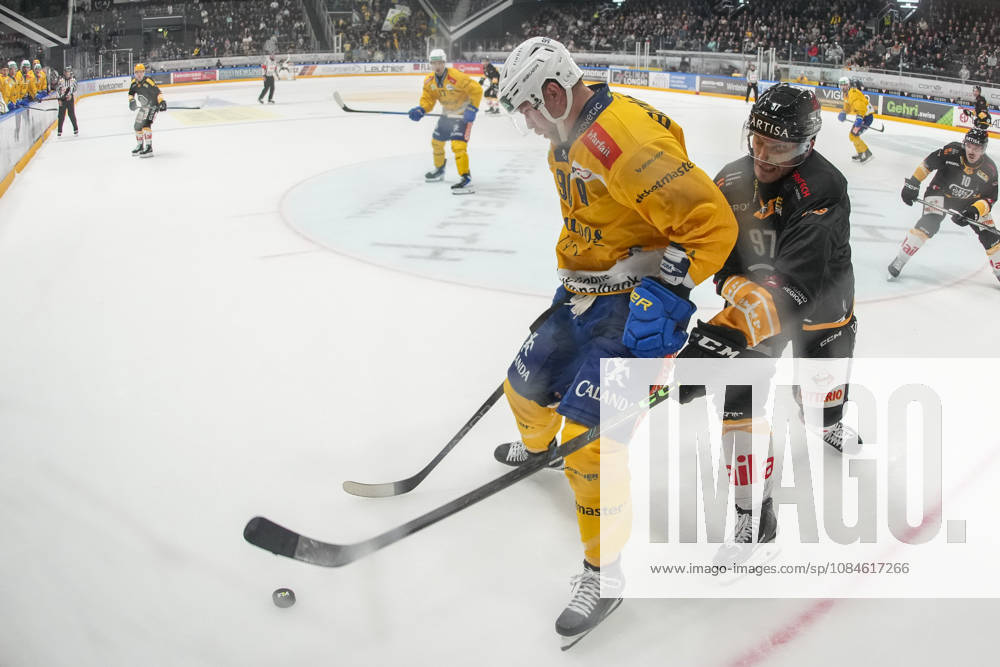 Sven Jung of Davos L) against Calvin Thurkauf of Lugano R) during the game between HC Lugano v HC Davos at the Corner Arena on October 16, 2026 in Lugano, Switzerland. Lugano Ticino Switzerland