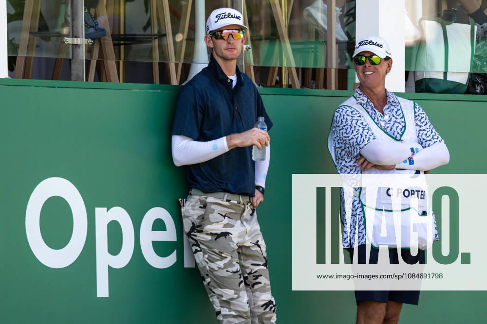 Charles PORTER from the USA takes the tied lead on -14 Par with a stunning -9 Par final round. PORTER and his caddy hide from the heat in the shade of the hospitality stand on the 18th green. Macau Open Golf 2026 Final Round. Macau China - ZUMAr144 20261018_zap_r144_043