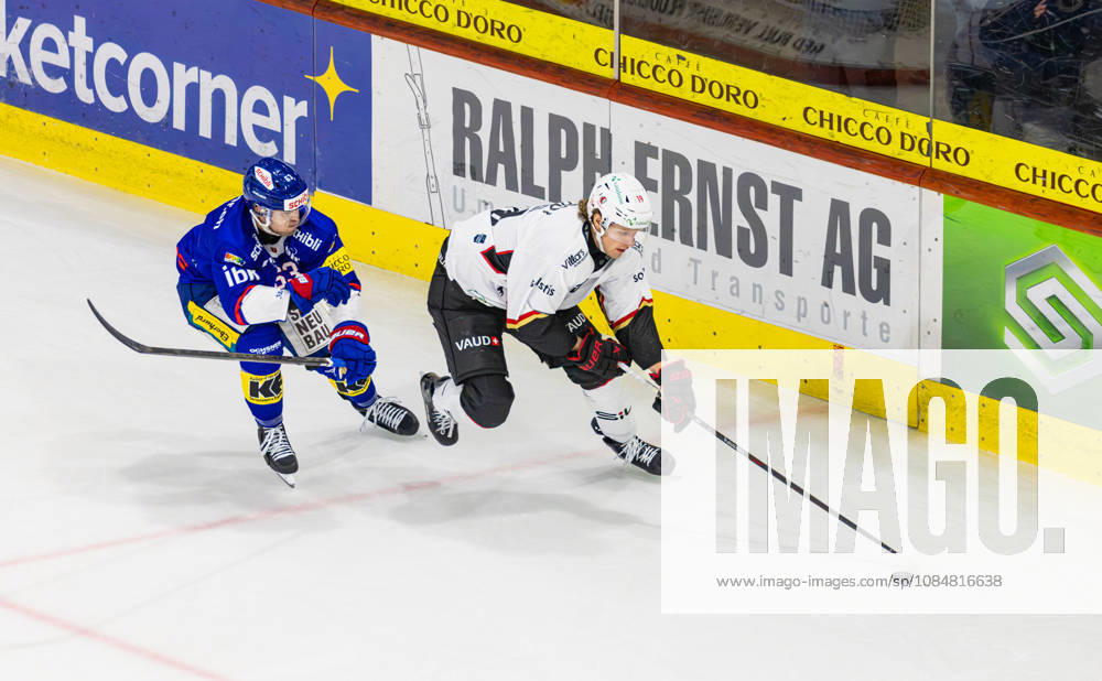Ice hockey, Eishockey National League Regular Season - EHC Kloten vs Lausan Kloten, Switzerland, 20th Oct 2026: 19 Ray Fust (Lausanne) defends the puck against 63 Fabio Murer (Kloten).