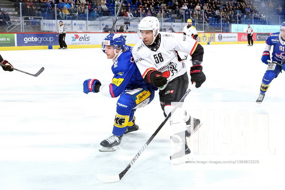 Swiss Ice hockey, Eishockey - EHC Kloten vs Lausanne Hockey - Lausanne Defender Romain Loeffel (58) fights with EHC Kloten Forward Keanu Derungs (11)