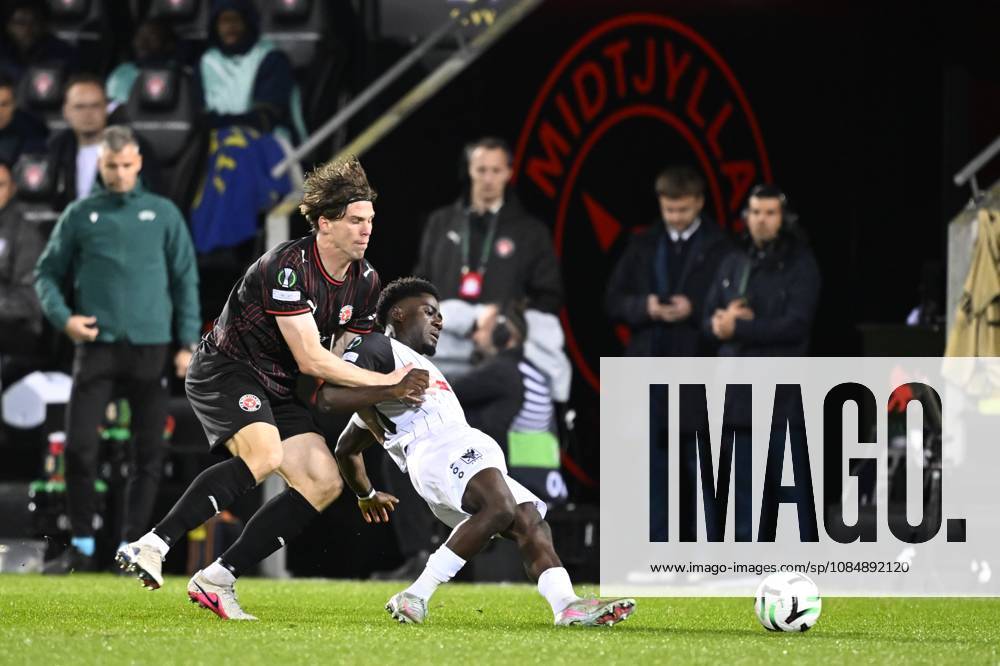 FC Midtjylland v Sint-Truidense VV - UEFA Conference League HERNING, DENMARK - OCTOBER 22 : Bech Mads defender of Midtjylland and Mbuku Nathanael forward of Sint-Truidense VV during the UEFA Conference League 2026 27 League Phase matchday 2 match between FC Midtjylland and Sint-Truidense VV on October 22, 2026 in Herning, Denmark, 22 10 2026 Herning Denmark