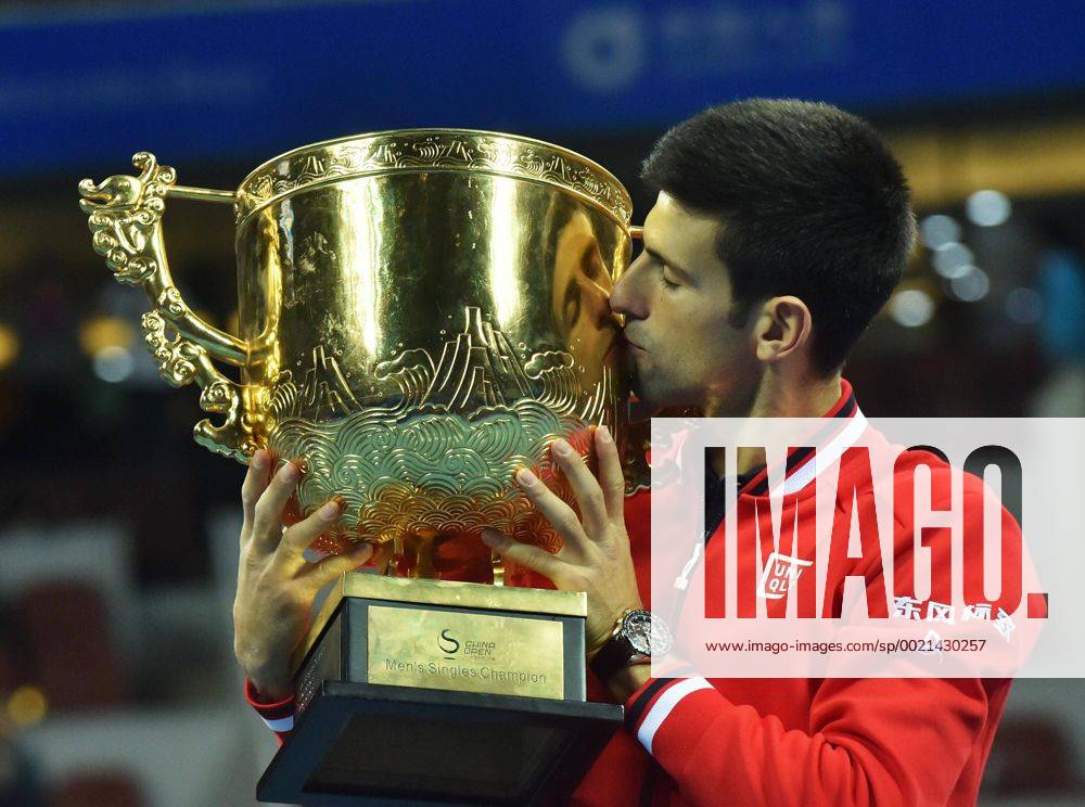 (151011) -- BEIJING, Oct. 11, 2015 -- Novak Djokovic of Serbia kisses his champion trophy during the awarding ceremony for the men s singles final at 2015 China Open Tennis Tournament in Beijing, China, Oct. 11, 2015. Djokovic claimed the title of the event after beating Rafael Nadal of Spain 2-0. ) (SP)CHINA-BEIJING-TENNIS-CHINA OPEN-MEN S SINGLES-FINAL LixWen