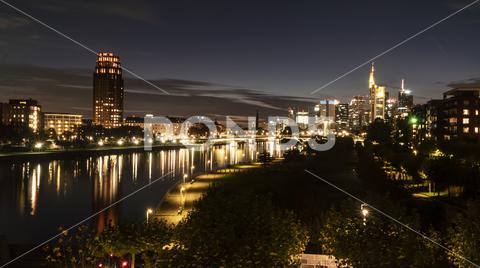 FRANKFURT am MAIN, GERMANY 2019 OCTOBER 05 Illuminated Cityscape Night View Frankfurt am Maine Germany architecture, background, brick, bridge, river, main, building, buildings, business, centre, city, cityscape, dark, downtown, editorial, europe, european, famous, frankfurt, frankfurt am main, mainhattan, germany, illuminated, park, sky, clouds, skyline, hotel, lindner, commerzbank
