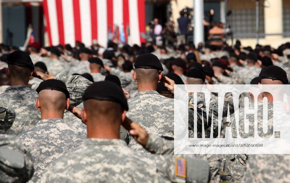 Army soldiers salute for the National Anthem during the III Corps and Fort Hood Memorial Ceremony, held to honor the 13 victims of the November 5 shootings in Killeen, Texas on November 10, 2009. DFW2009111007