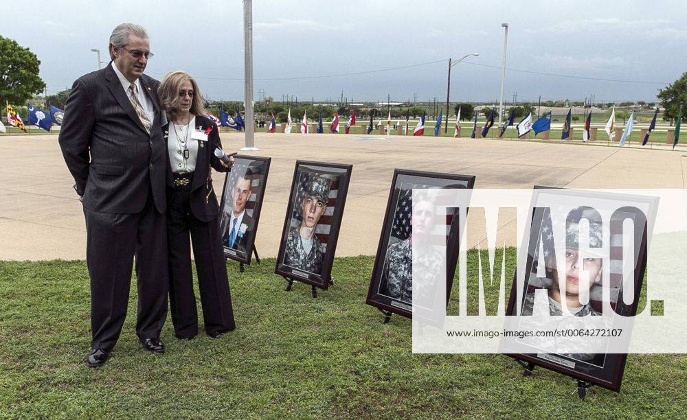 Fort Hood, Texas, U.S - Jeffrey and Sheryll Pearson, parents of Pfc. Michael Pearson, second picture from right, who was killed during the attack by Maj. Nidal Hasan in the 2009 Fort Hood shooting, visit in front of his picture prior to a Purple Heart ceremony held at Fort Hood, Texas, Friday, April 10, 2015. Survivors and family members of those killed during the attack were awarded medals: a Purple Heart for soldiers and Defense of Freedom Medals for civilians. Fort Hood U.S. - ZUMAp124