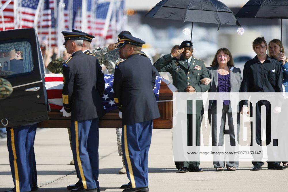 _San Diego_California_USA_(LtoR) California Army National Guard Casuelity Assistance Officer Maj. Timothy Grimes and Christine Gaffaney, widow Army Capt. John Gaffaney and Matthew Gaffaney son of Army Capt. John Gaffaney of Serra Mesa who was killed at Fort Hood watch his casket being loaded into a hearse. Capt. Gaffaney was flown to MCAS Miramar to be handed over to his family._Mandatory Photo - ZUMAs44_