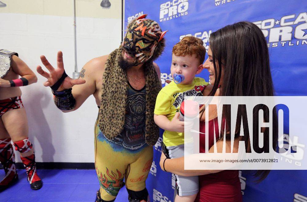 Oceanside, California, USA - 10 15 2016_Oceanside, CA_SoCal Pro Wrestling s Rumble in Oceanside event at the Oceanside Boys & Girls Club gymnasium. During intermission wrestler Motros Jungle has his photo taken with fans Arkady Unterleidner and her son Tyson, 2._Photo by Oceanside USA - ZUMAn47_