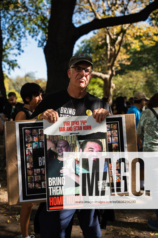 A demonstrator holds a sign as hundreds rally in Central Park in support of a deal to end the war in Gaza and free the remaining Israeli hostages in a rally that marks two years since the war began. The negotiating teams are set to start finalizing the details of a ceasefire on Monday according to US President Donald TrumpÃ¢â‚¬â ¢s peace plan. New York USA - ZUMAg280 20251005_znp_g280_001