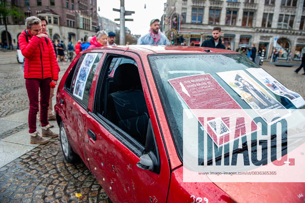A woman in red clothes cries as she inspects a car full of bullets. A vehicle representing five-year-old Hind Rajab and her family, who were killed during an Israeli army attack in the Tel al-Hawa area of Gaza in January 2024, has been exhibited in the Netherlands. Amsterdam Netherlands - ZUMAs197 20251005_aaa_s197_618