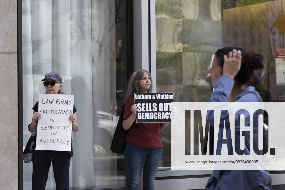 Demonstrators with the activist group Rise and Resist hold signs that read LAW FIRMS CAPITULATION IS COMPLICITY IN AUTOCRACY Latham and Watkins SELLS OUT DEMOCRACY outside of the offices of Latham and Watkins LLP in midtown Manhattan as lunchtime crowds pass. Protesters stage a peaceful demonstration denouncing the law firm s agreement to provide millions in pro bono legal work to initiatives from President TrumpÃ¢â‚¬â ¢s agenda and to abandon diversity, equity, and inclusion (DEI) policies. New York USA - ZUMAr174 20251007_znp_r174_035