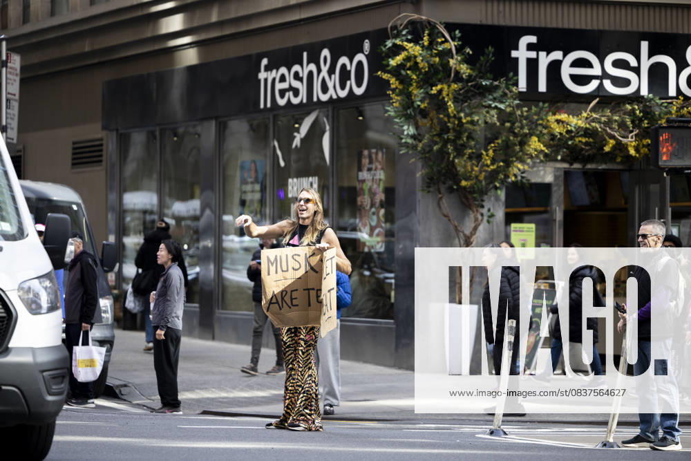 A protester holds a sign. Demonstrators fill streets across cities and towns nationwide during the â€oeNo Kings†protest, denouncing the policies of the Trump administration. New York USA - ZUMAh182 20251018_znp_h182_011