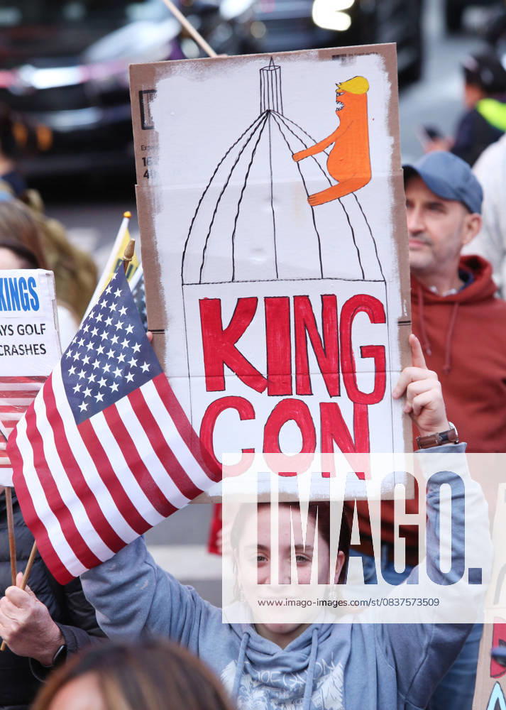 A woman holds a sign that says King Con during the No Kings protest in New York City on Oct. 18, 2025. Tens of thousands of people hit New York City streets to protest Donald Trump, autocracy, ICE and immigrant deportations. More than 2,500 similar protests took place nationwide. New York City USA - ZUMAk45_ 20251018_zaf_k45_018