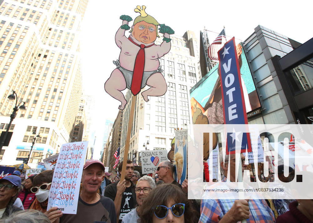 A man holds a sign during the No Kings protest in New York City on Oct. 18, 2025. Tens of thousands of people hit New York City streets to protest Donald Trump, autocracy, ICE and immigrant deportations. More than 2,500 similar protests took place nationwide. New York City USA - ZUMAk45_ 20251018_zaf_k45_037