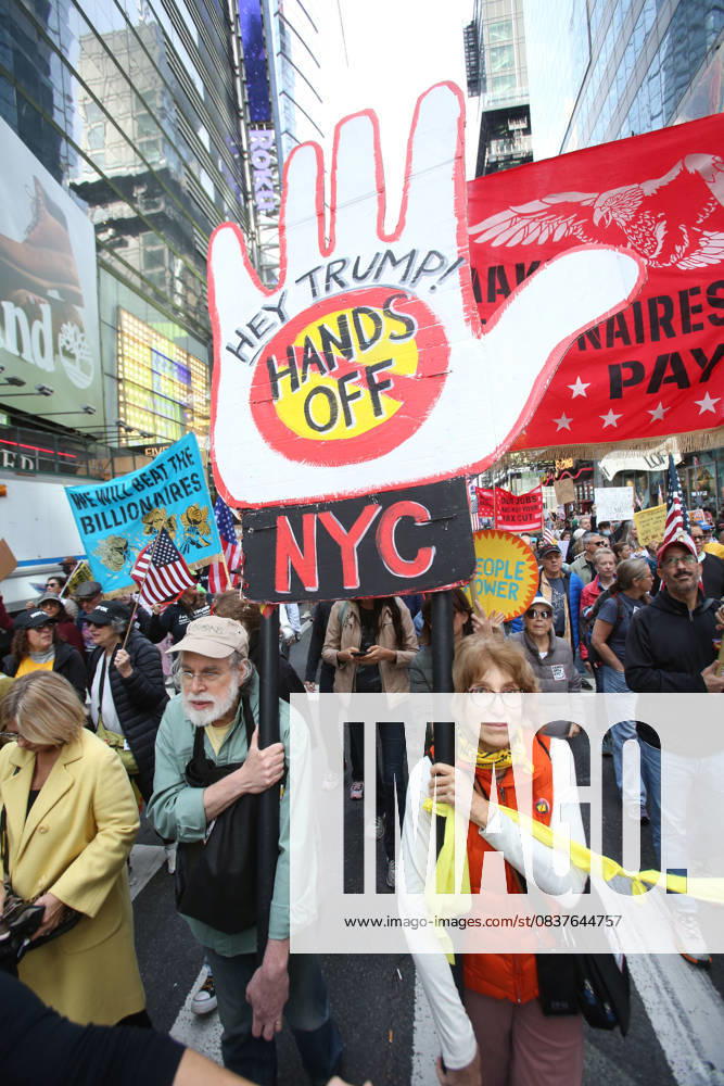 A man holds a sign that says Hey Trump, Hands off NYC during the No Kings protest in New York City on Oct. 18, 2025. Tens of thousands of people hit New York City streets to protest Donald Trump, autocracy, ICE and immigrant deportations. More than 2,500 similar protests took place nationwide. New York City USA - ZUMAk45_ 20251018_zaf_k45_058