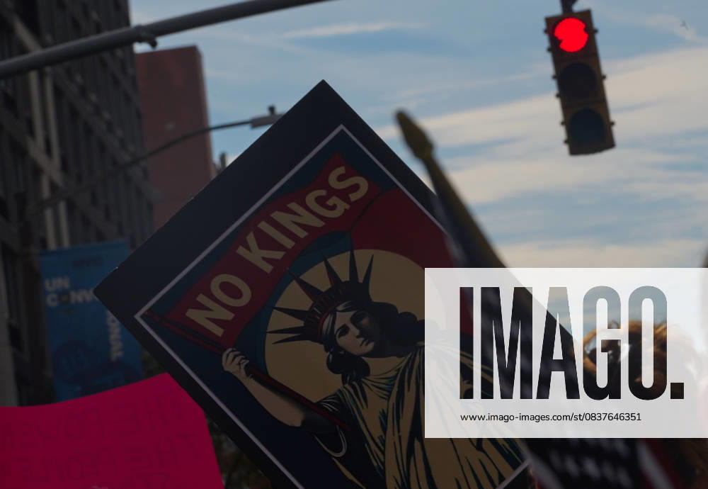 Protester holds a Statue of Liberty No Kings sign along 7th Avenue protest route in opposition to measures Donald Trump has taken to install authoritarian style rule. New York USA - ZUMAl171 20251018_znp_l171_023