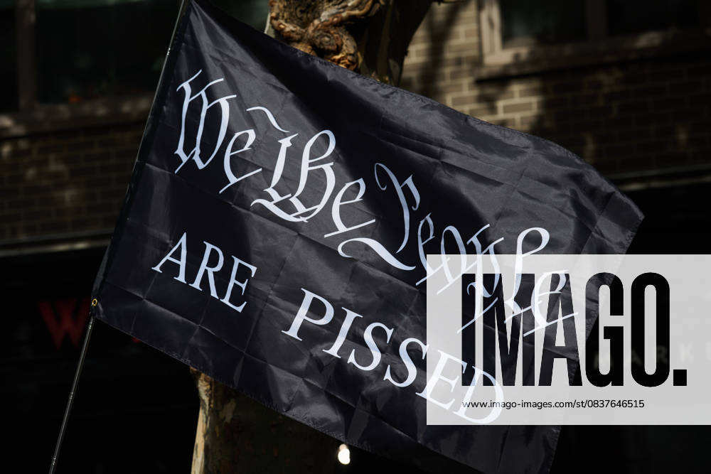 Protester holds black flag that reads, â€oeWe The People Are Pissed†in the New York City No Kings protest in opposition to measures Donald Trump has taken to install authoritarian style rule. New York USA - ZUMAl171 20251018_znp_l171_035