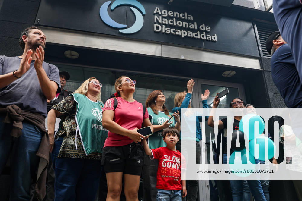 Relatives of people with disabilities listen to a speech outside the National Disability Agency during a demonstration demanding enforcement of the Disability Emergency Law. Buenos Aires Argentina - ZUMAp265 20251022_zip_p265_001