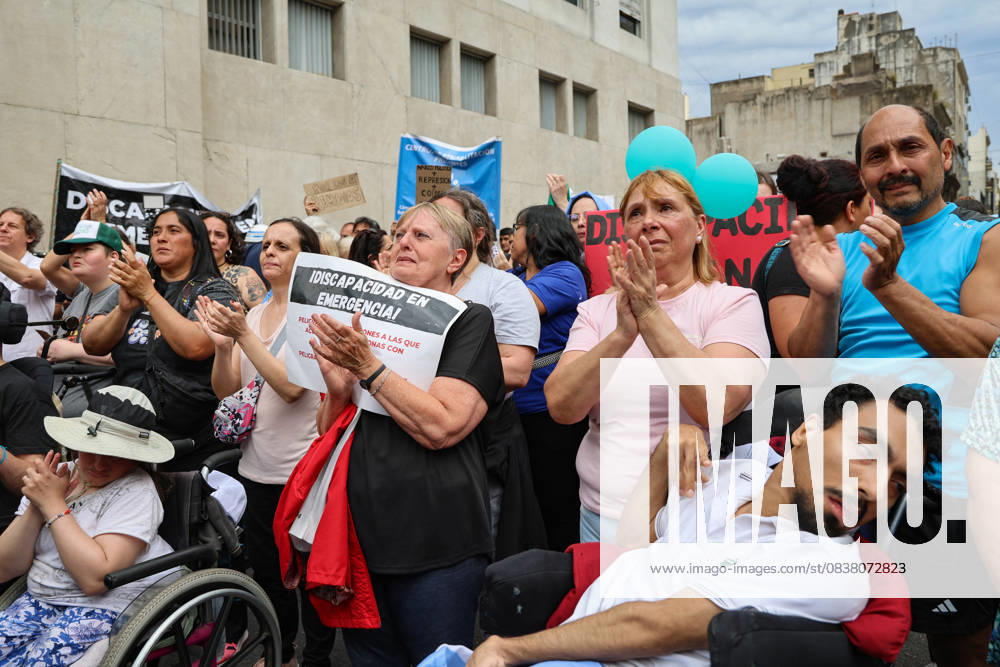 Relatives of people with disabilities applaud a speech near the National Ministry of Health during a demonstration urging the executive branch to enforce the Disability Emergency Law. Buenos Aires Argentina - ZUMAp265 20251022_zip_p265_008