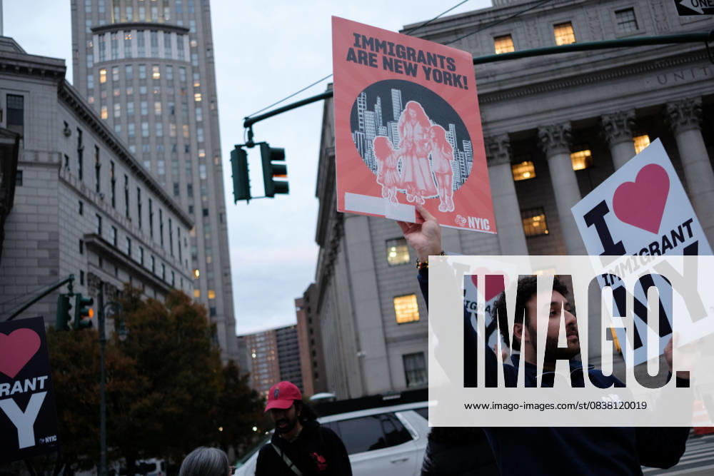 A protester holds signs saying â€oeImmigrants are New York†and â€oeI Love Immigrant NY†during a demonstration at Foley Square, in New York, on Wednesday, Oct. 22, 2025. This response comes after more than 50 federal agents arrested immigrant vendors at Canal Street, lower Manhattan, on Tuesday. New York USA - ZUMAs368 20251022_zip_s368_017