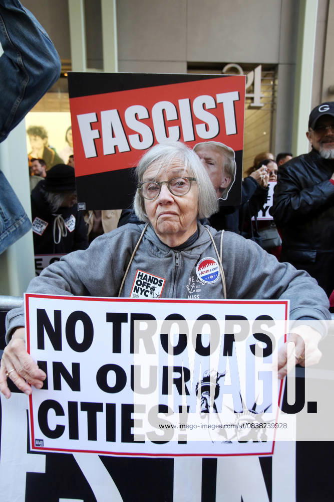 A woman holds a sign that says No Troops in our Cities during a Hands Off NYC rally. outside of Trump Tower. Some women wore polka dots in honor of a protestor who confronted ICE agents and tank vehicles. The peaceful rally drew a handful of Trump supporters. New York City USA - ZUMAk45_ 20251025_zaf_k45_009