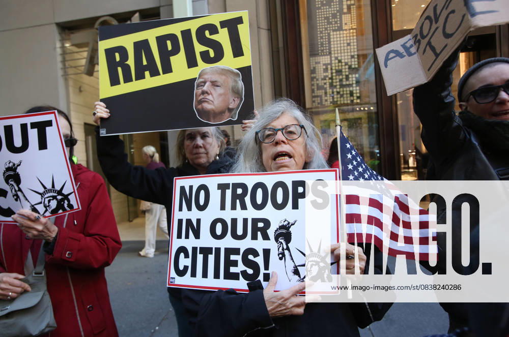 A woman holds a sign that says No Troops in our Cities during a Hands Off NYC rally. outside of Trump Tower on October 25, 2025. Some women wore polka dots in honor of a protestor who confronted ICE agents and tank vehicles. The peaceful rally drew a handful of Trump supporters. New York City USA - ZUMAk45_ 20251025_zaf_k45_012