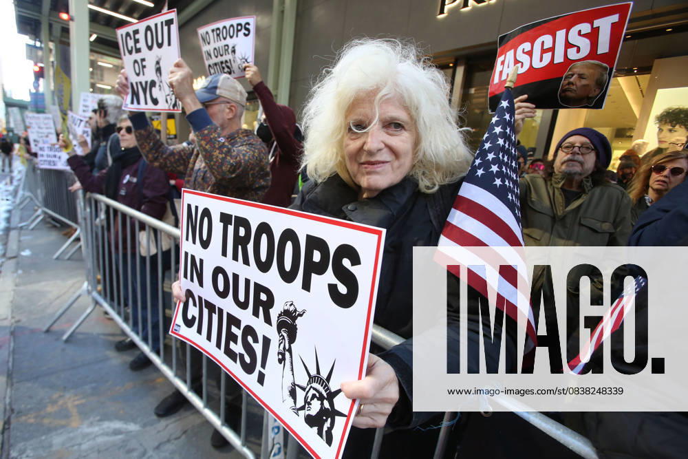 A woman holds a sign during a Hands Off NYC rally outside of Trump Tower on October 25, 2025. Some women wore polka dots in honor of a protestor who confronted ICE agents and tank vehicles. The peaceful rally drew a handful of Trump supporters. New York City USA - ZUMAk45_ 20251025_zaf_k45_039
