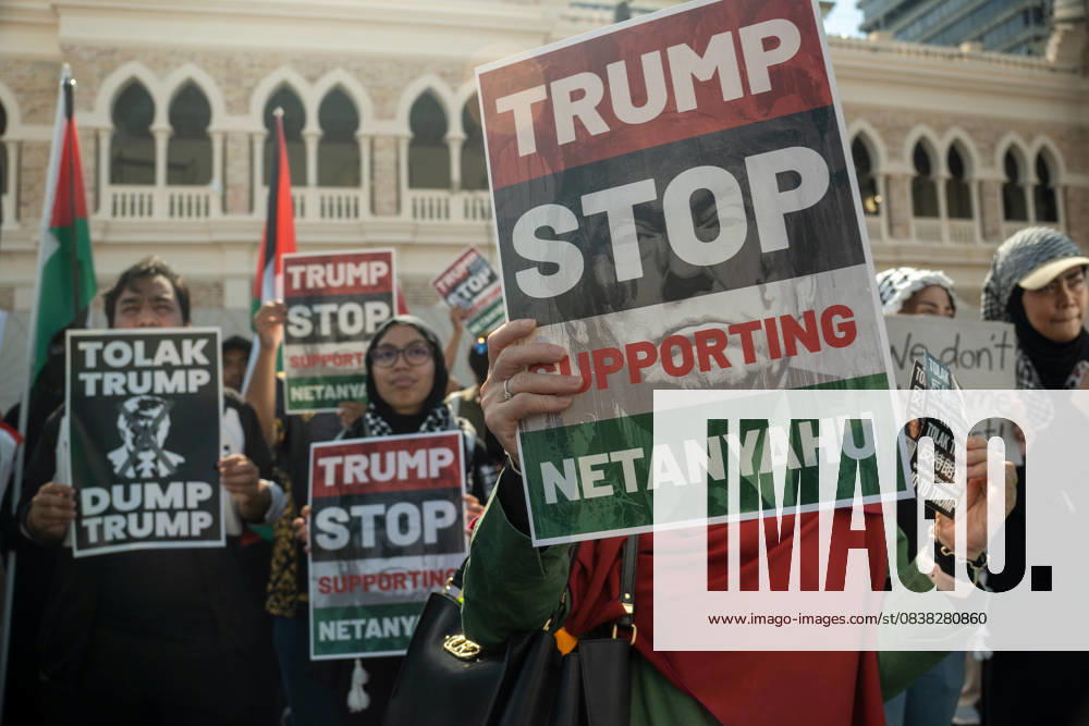 Protesters hold placards during a protest against US President Donald Trump s visit for the Association of Southeast Asian Nations (ASEAN) 47th ASEAN Summit in Kuala Lumpur. Kuala Lumpur Malaysia - ZUMAr146 20251026_zap_r146_001