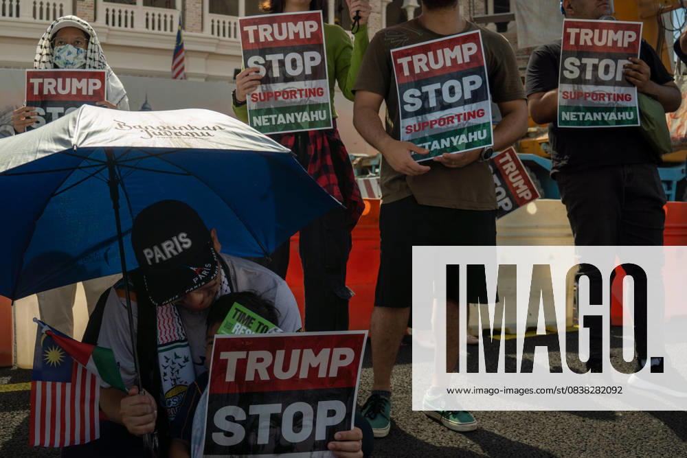 Protesters hold placards during a protest against US President Donald Trump s visit for the Association of Southeast Asian Nations (ASEAN) 47th ASEAN Summit in Kuala Lumpur. Kuala Lumpur Malaysia - ZUMAr146 20251026_zap_r146_008