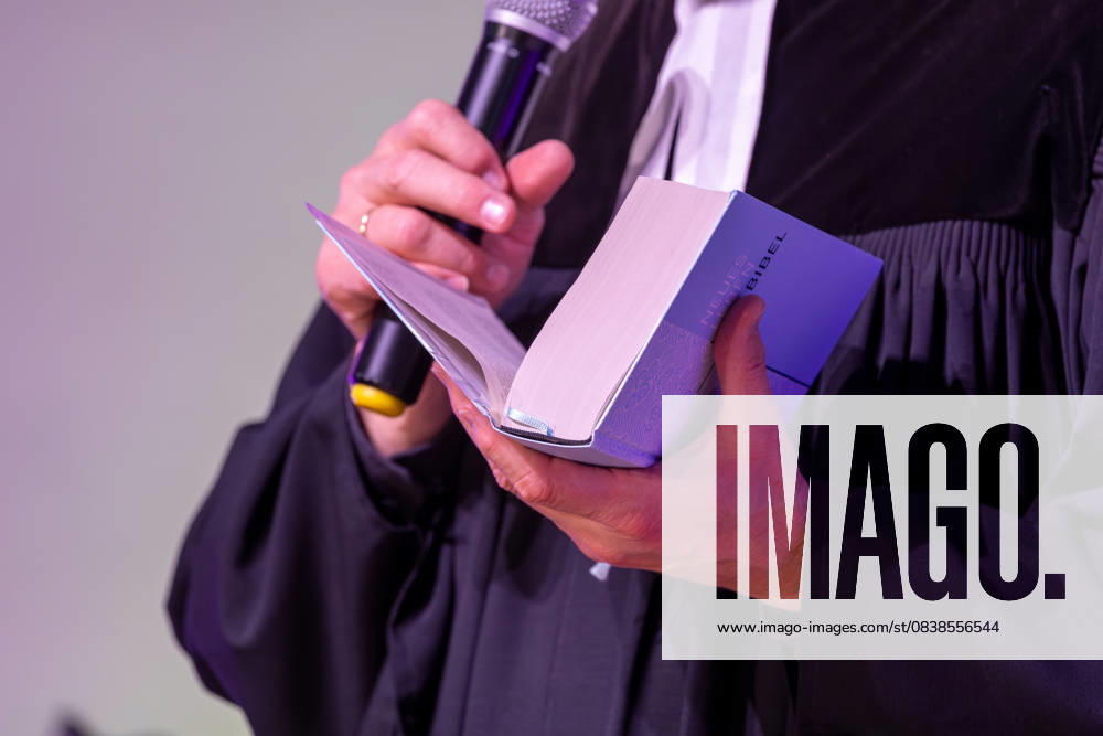Protestantischer Pfarrer hält eine Bibel in der Hand (Symbolbild Kirche)
