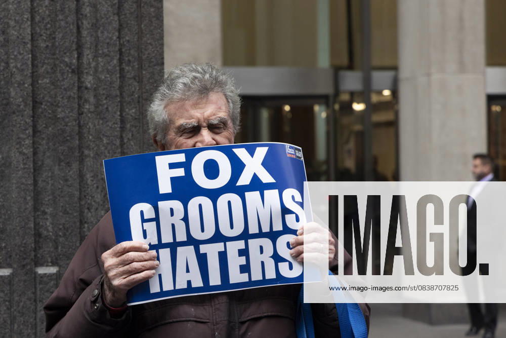 A demonstrator holds a sign that reads FOX grooms HATERS joining peaceful protesters outside of News Corp s Fox News Channel in midtown Manhattan. People with the activist groups Rise & Resist and Truth Tuesdays call for truth in journalism and denounce ICE, Federal troops sent to cities and Fox News as extremist right-wing propaganda in support of President Trump s administration. New York USA - ZUMAr174 20251028_znp_r174_025