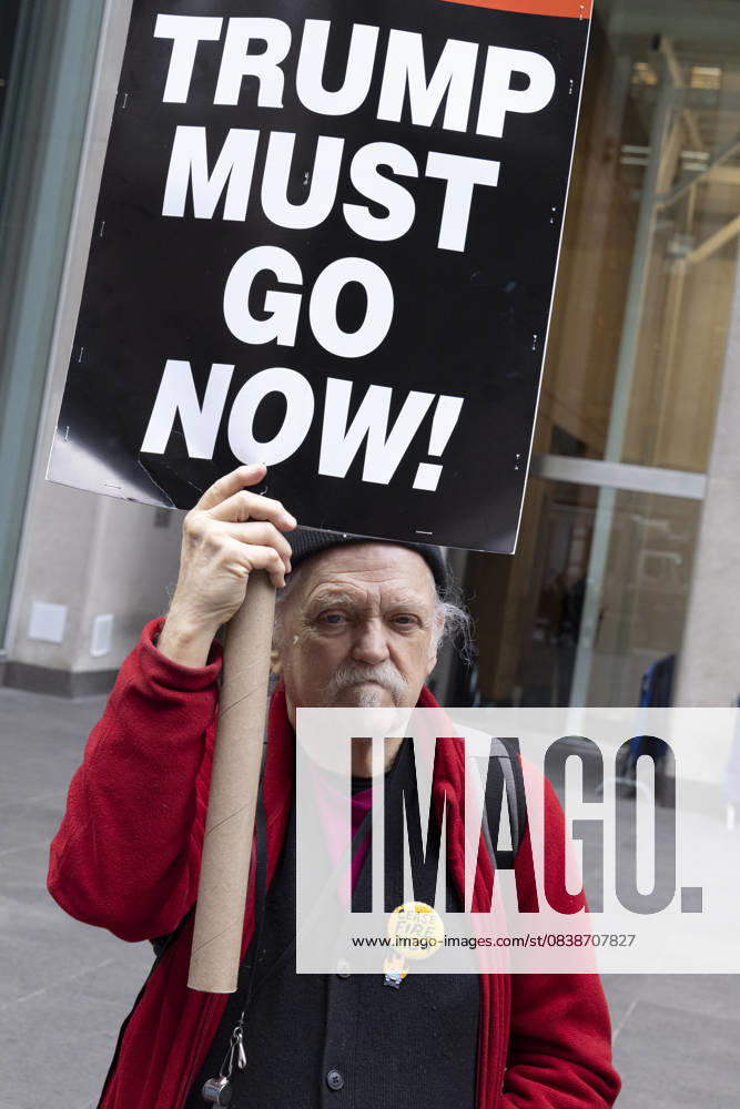 A demonstrator holds a sign that reads TRUMP MUST GO NOW! joining peaceful protesters outside of News Corp s Fox News Channel in midtown Manhattan. People with the activist groups Rise & Resist and Truth Tuesdays call for truth in journalism and denounce ICE, Federal troops sent to cities and Fox News as extremist right-wing propaganda in support of President Trump s administration. New York USA - ZUMAr174 20251028_znp_r174_027